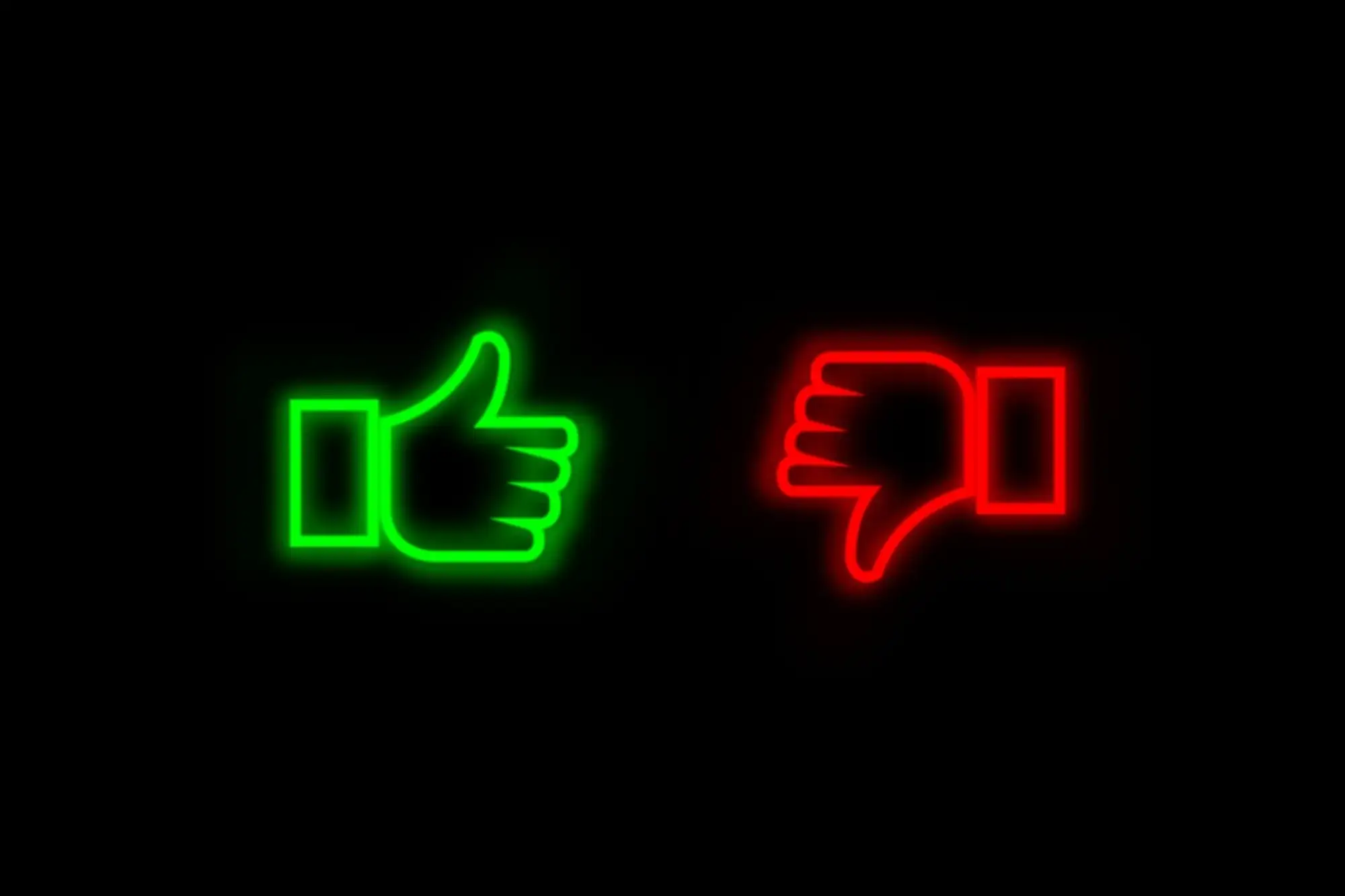 Green thumb up and red thumb down against black background